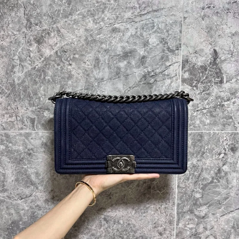 Chanel bags with exclusive seasonal designs and materialsCaviar Boy Medium Navy Blue No 19